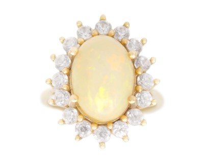 Lot 72 - A 9k gold opal and white topaz dress ring.