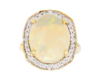 Lot 78 - LORIQUE - an 18k gold large opal and diamond halo dress ring.