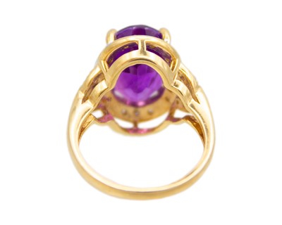 Lot 64 - A 9k gold Siberian amethyst and diamond dress ring.