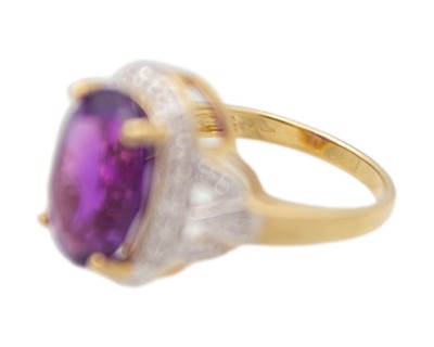 Lot 64 - A 9k gold Siberian amethyst and diamond dress ring.