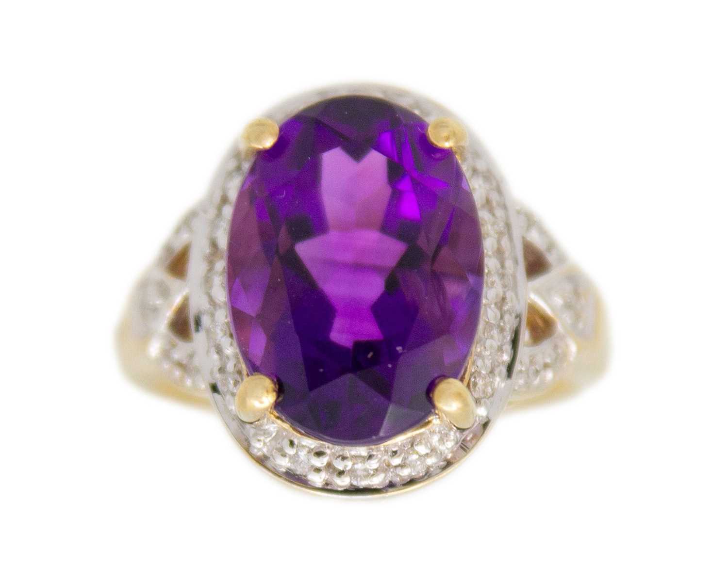 Lot 64 - A 9k gold Siberian amethyst and diamond dress ring.