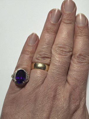 Lot 64 - A 9k gold Siberian amethyst and diamond dress ring.
