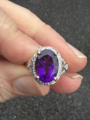 Lot 64 - A 9k gold Siberian amethyst and diamond dress ring.