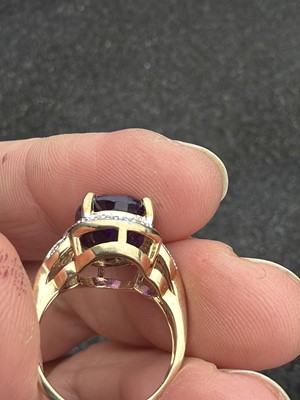 Lot 64 - A 9k gold Siberian amethyst and diamond dress ring.
