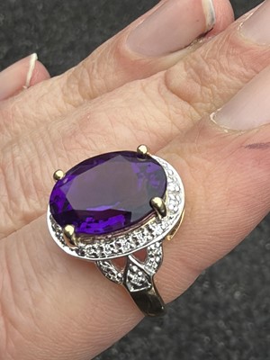 Lot 64 - A 9k gold Siberian amethyst and diamond dress ring.