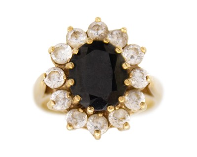 Lot 65 - A 9k gold sapphire and white paste cluster ring.