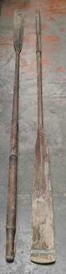 Lot 749B - A pair of wooden oars with leather grips.