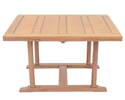 Lot 678 - An oak Arts and Crafts Cotswold school drawleaf dining table.