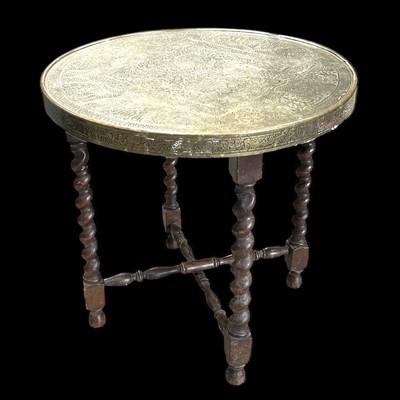 Lot 163 - A brass Benares-style table on folding legs,...