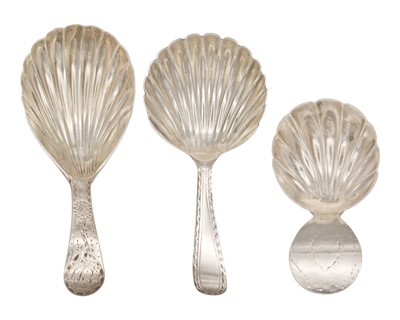 Lot 6 - A selection of three George III silver caddy spoons with scallop shell bowls and bright cut handles.