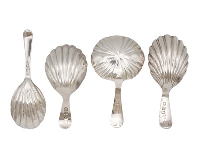 Lot 7 - A collection of four George III silver caddy spoons with scalloped bowls.