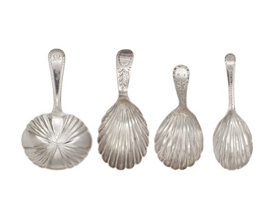 Lot 7 - A collection of four George III silver caddy spoons with scalloped bowls.