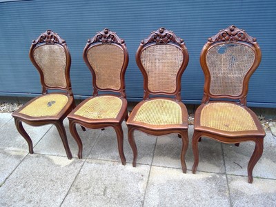 Lot 111 - Four Heavily Carved Dining Chairs with Cane...
