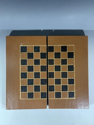 Lot 32 - A Leather bound folding chess board, as two...