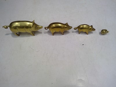 Lot 200 - Four Brass Pigs, the largest is 7cm tall by...