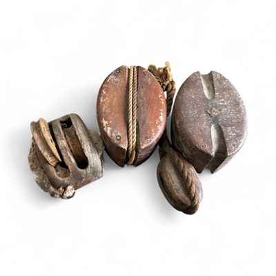 Lot 64 - Four antique ships pulleys, the largest being...