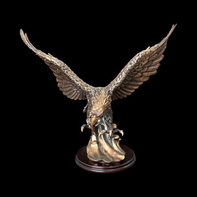 Lot 68 - A large resin-coated sculpture of an eagle,...