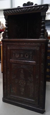 Lot 20 - A Heavily Carved Oak Corner Cupboard. The...