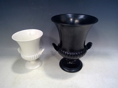 Lot 24 - Two Wedgwood Urns. The Black Urn is 25cm tall...