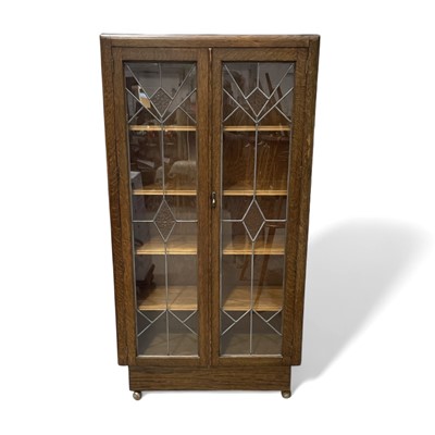 Lot 57 - A glazed oak display cabinet with four shelves...