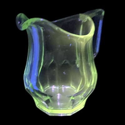 Lot 115 - A vintage uranium glass jug, 17cm tall.