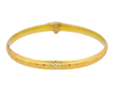 Lot 14 - A higher purity gold hinged bangle.
