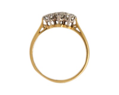Lot 32 - An 18k gold three-stone diamond ring.