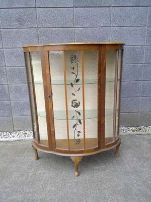 Lot 133 - A Bow Front Display Cabinet. The Cabinet is...