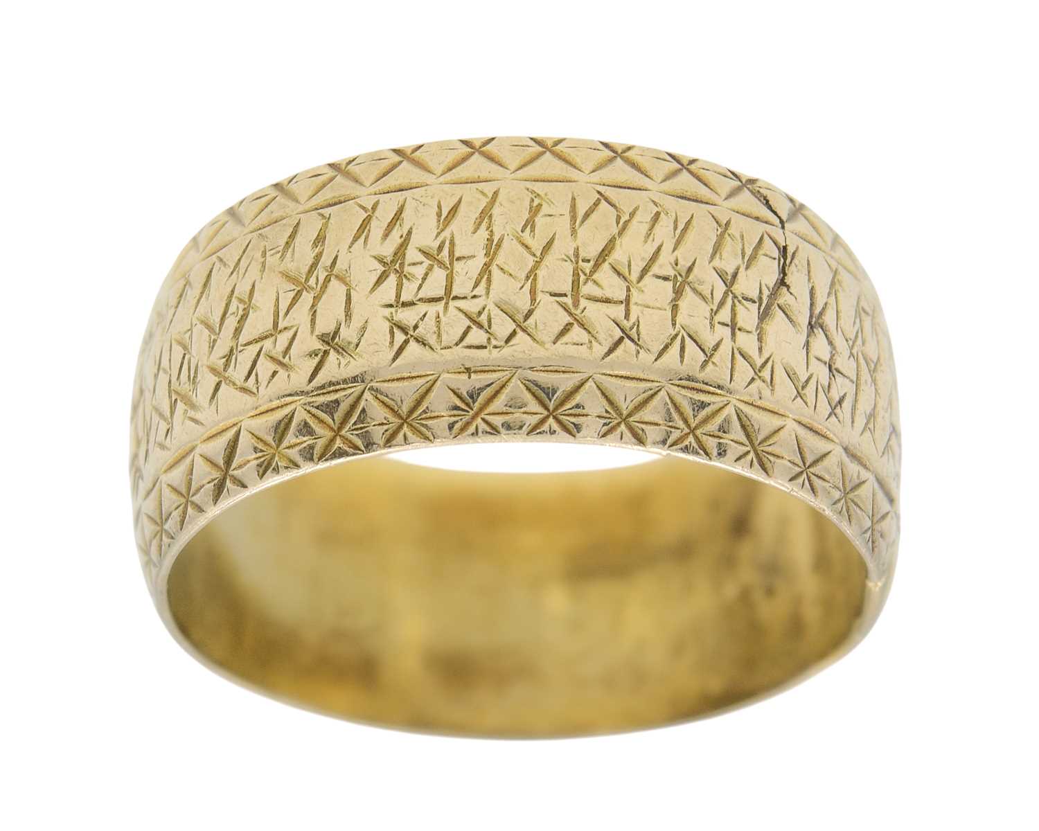 Lot 23 - A 9k gold wide engraved band ring.