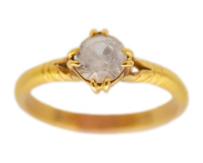 Lot 39 - A high-purity gold and white synthetic sapphire solitaire ring.