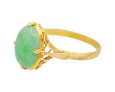 Lot 42 - A 21k gold and jade solitaire ring.