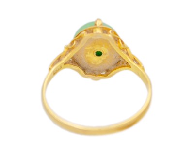 Lot 42 - A 21k gold and jade solitaire ring.