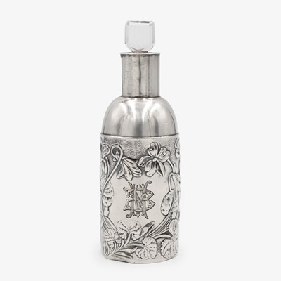Lot 220 - An Edwardian Art Nouveau silver-mounted clear glass scent bottle by William Comyns.