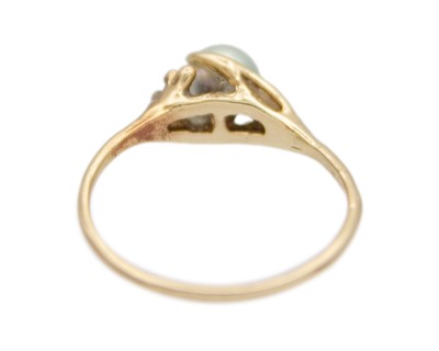 Lot 68 - A higher purity gold and pearl solitaire ring.