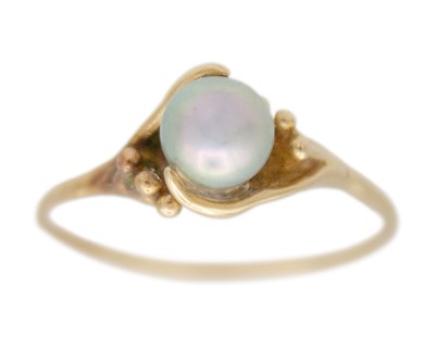 Lot 118 - A higher purity gold and pearl solitaire ring.