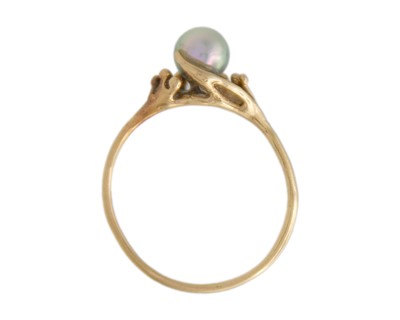 Lot 68 - A higher purity gold and pearl solitaire ring.