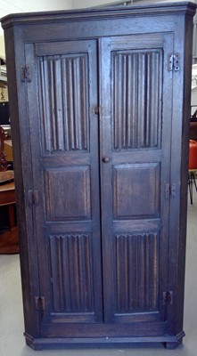 Lot 116 - A Vintage Oak Corner Wardrobe. The piece is...