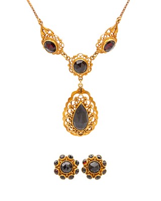 Lot 151 - A 14k rose gold and garnet pendant necklace with a pair of earrings.