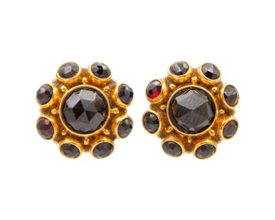 Lot 23 - A 14k rose gold and garnet pendant necklace with a pair of matched earrings.