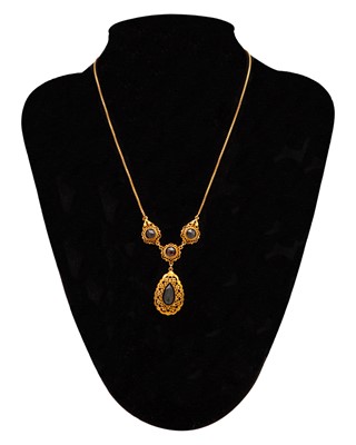 Lot 23 - A 14k rose gold and garnet pendant necklace with a pair of matched earrings.