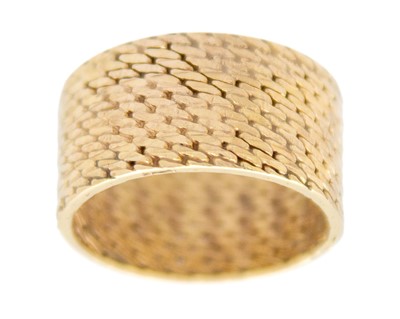 Lot 132 - A 9k gold mesh link wide band ring.