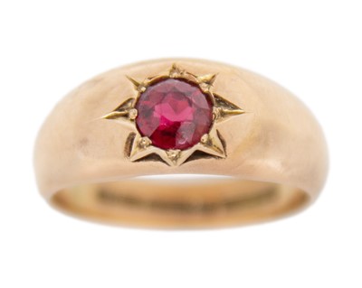 Lot 135 - A 9k rose gold garnet gypsy ring.