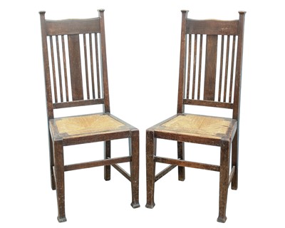 Lot 205 - A pair of Arts and Crafts oak dining chairs.