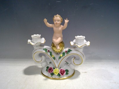 Lot 33 - A Dresden Cherub Candlestick. The piece is...