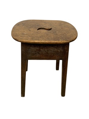 Lot 723 - A George III elm and oak stool.