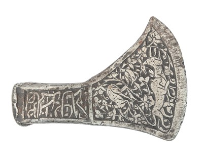 Lot 435 - A Persian Islamic silvered steel saddle axe.