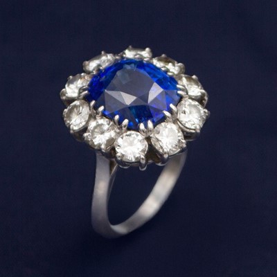 Lot An exceptional certified 9.40ct Burmese sapphire and diamond cluster ring.
