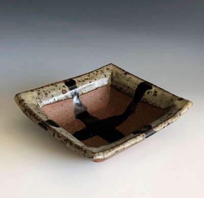 Lot 410 - A Janet Leach square dish with ash glazed rim...