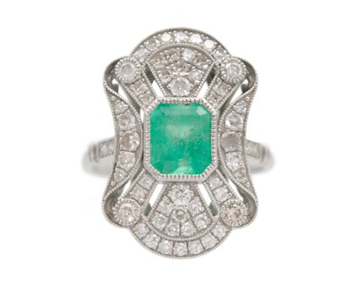 Lot 159 - An Art Deco-style emerald and diamond ring in platinum.