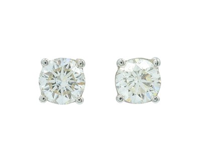 Lot 148 - A pair of 18k white gold diamond solitaire stud earrings.